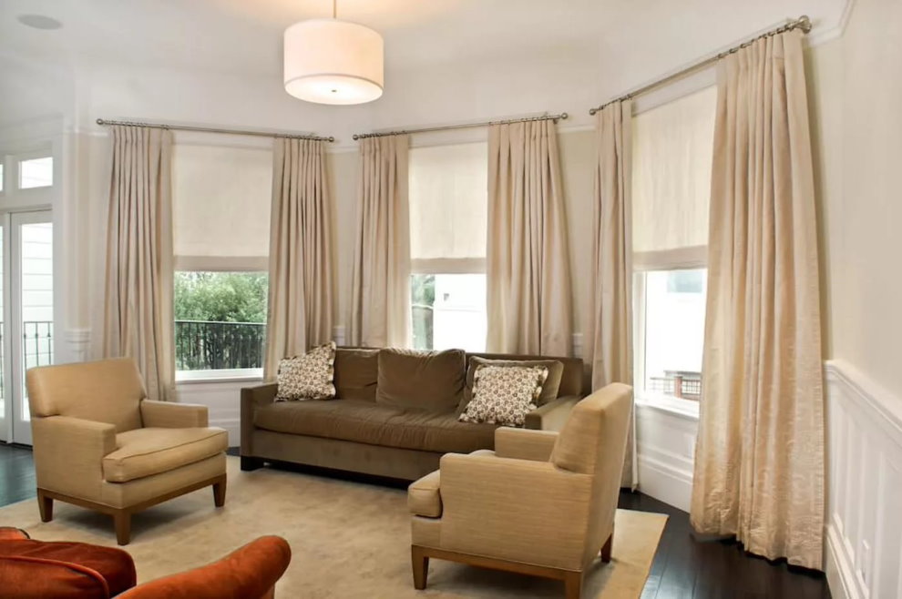 Beige curtains in the living room with bay window