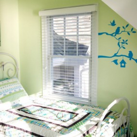 Baby cot in front of a small window