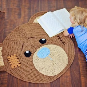 Open book in front of a children's rug