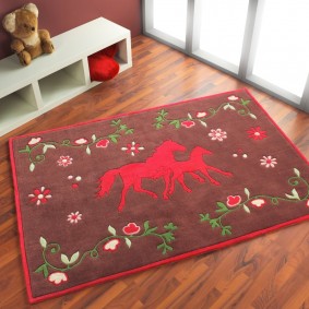Red horses on the mat in the nursery
