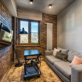 Small living room with brick wall
