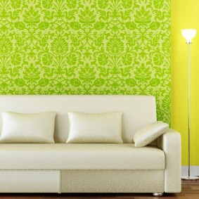 Green wallpaper behind a white sofa