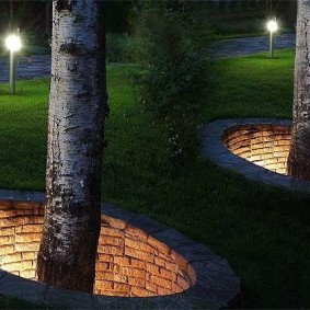 Beautiful illumination with a trunk of trees in a summer cottage