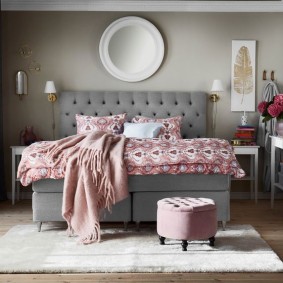 Gray bed in the bedroom of a city apartment