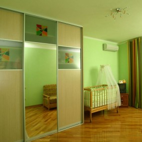 Green walls in the room for the baby