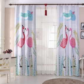 Pink flamingos on the curtains in the nursery
