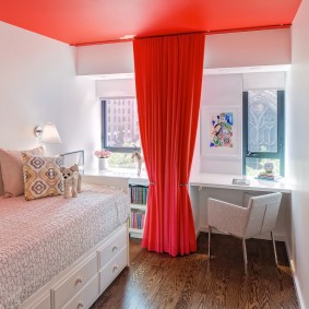 Red curtain in the bedroom of a modern girl