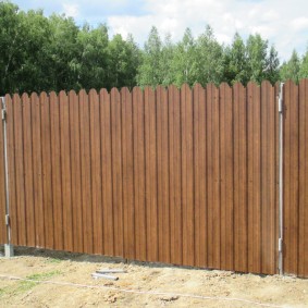 Solid fence made of metal picket fence
