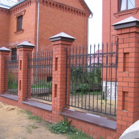 Metal fence on brick poles