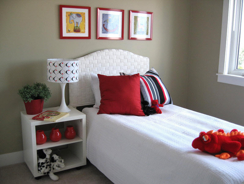 Red pillow on a white bed
