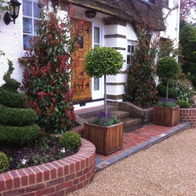 Brick flower beds in front of the main entrance to the house