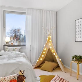 White curtains in a room with a playhouse