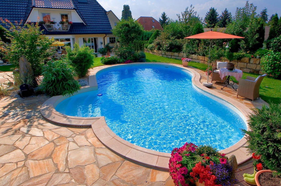 Stone platform in front of a pool with blue water