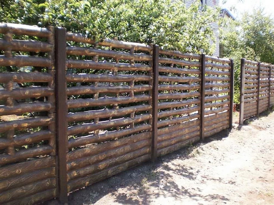Beautiful concrete fence with imitation of a wooden fence