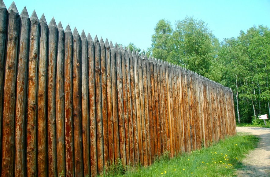 Garden fence with a wooden picket fence