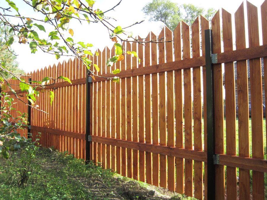 Wooden fence on metal poles