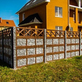 High fence in front of a two-story house