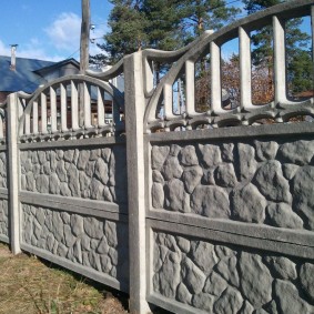 Prefabricated fence at the border of garden plots