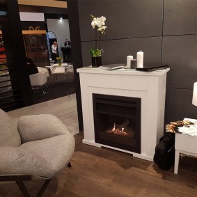 A comfortable armchair in front of the fireplace in the living room