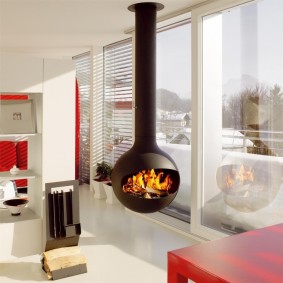 Hanging fireplace in front of a panoramic window