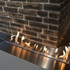 Built-in fireplace along a brick wall