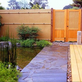 Stone walkway from home to wooden gate