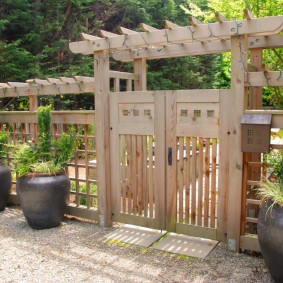 Wooden pergola in front of the cottage entrance