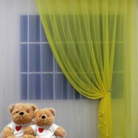 Çocuk için yatak odası penceresinde açık sarı tül