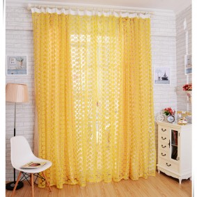 Rideaux jaunes dans une pièce avec des meubles blancs