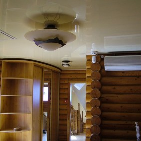 Stretch ceiling in a log house