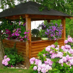 Decor of a garden arbor with flowers in pots