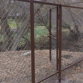 An open gate in a fence of a country site