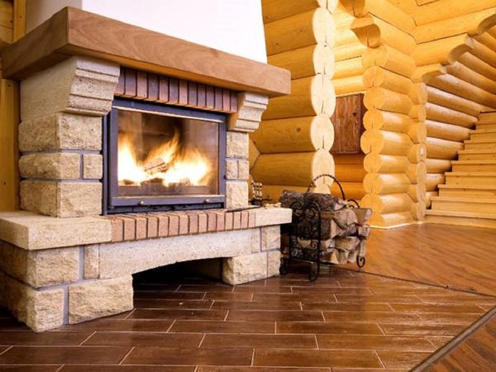 Stone fireplace in a log house