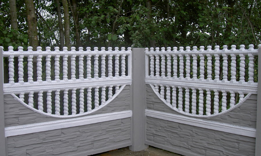 Painting sections of concrete fence in the country
