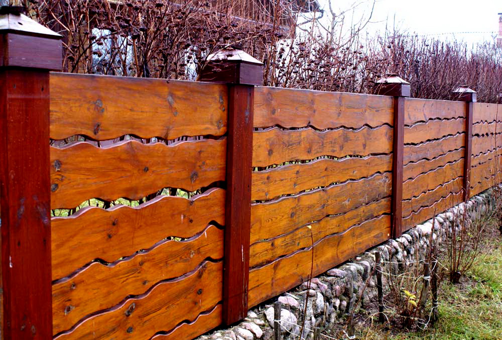 Stylish fence made of varnished boards