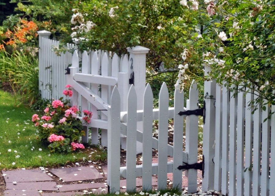 Low fence made of white picket fence