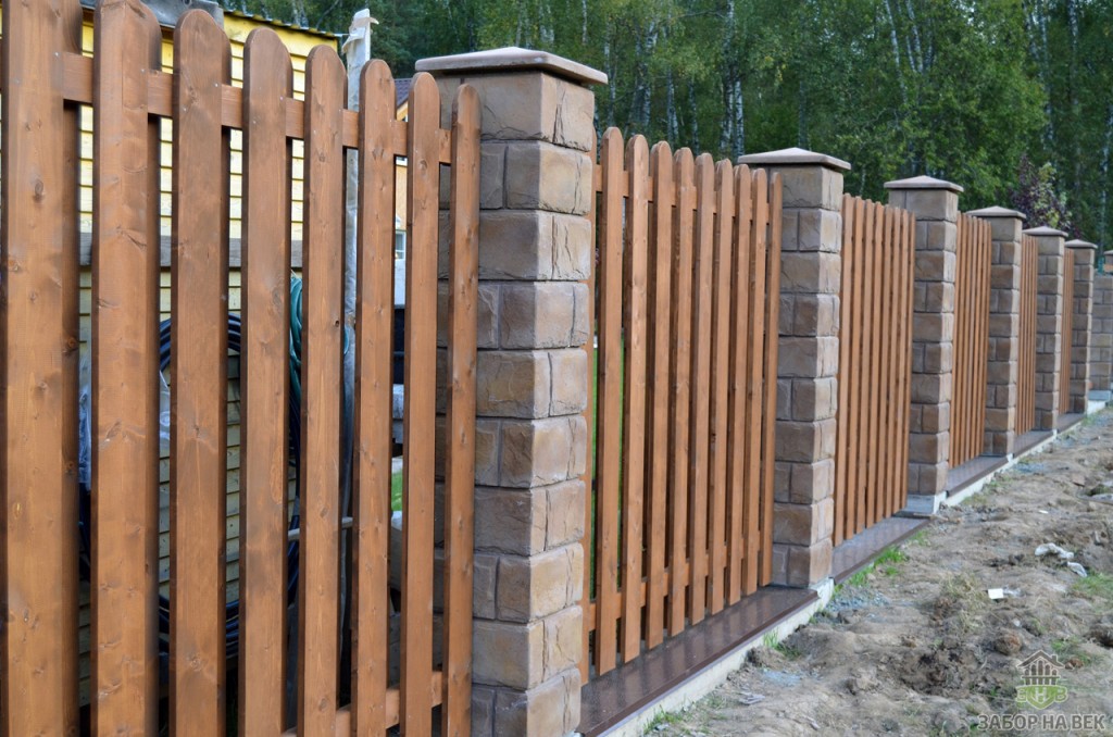 Wooden fence with gaps on brick pillars