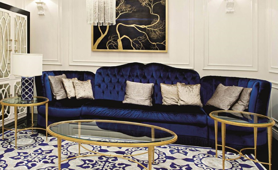 Zils dīvāns art deco stila viesistabas interjerā