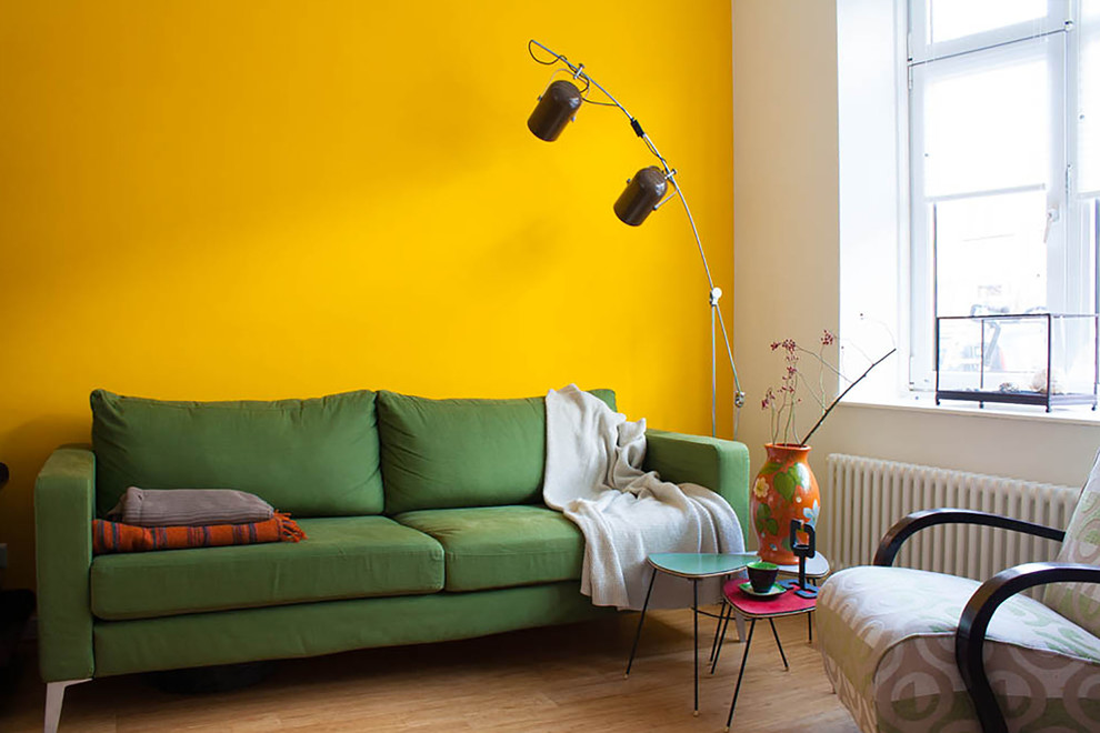 Green sofa near the yellow wall