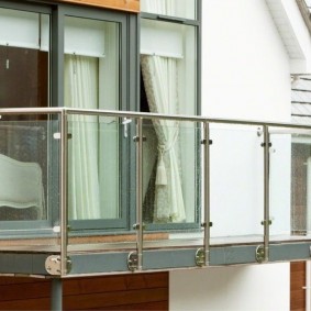 Glass screens between the columns of the balcony railing