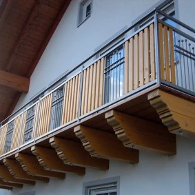 Wooden balcony in the house with an attic