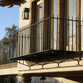 Metal balcony on the facade of a country house