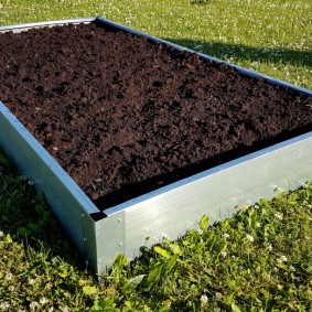 Black soil inside a raised bed of metal