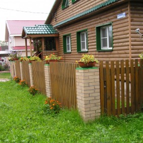 Wooden fence on brick poles