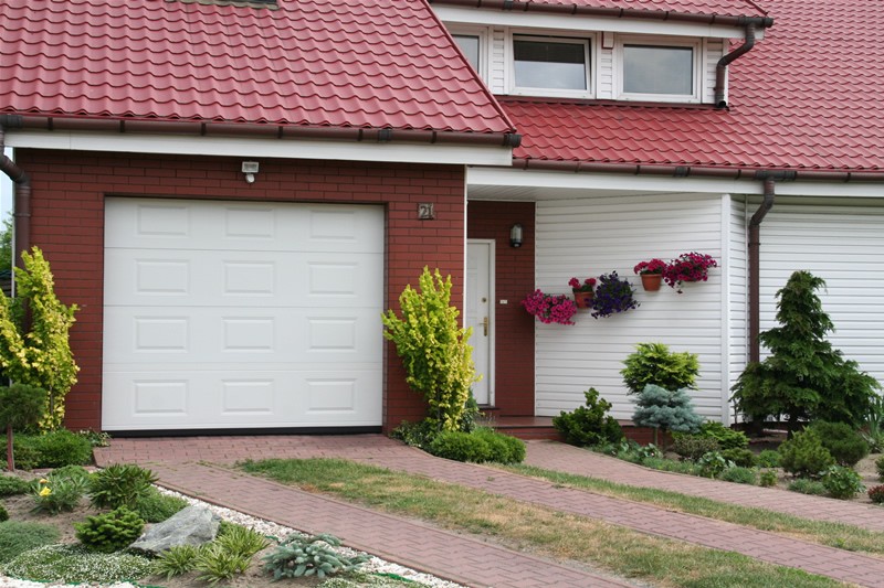 Garage in front of a residential building on a plot