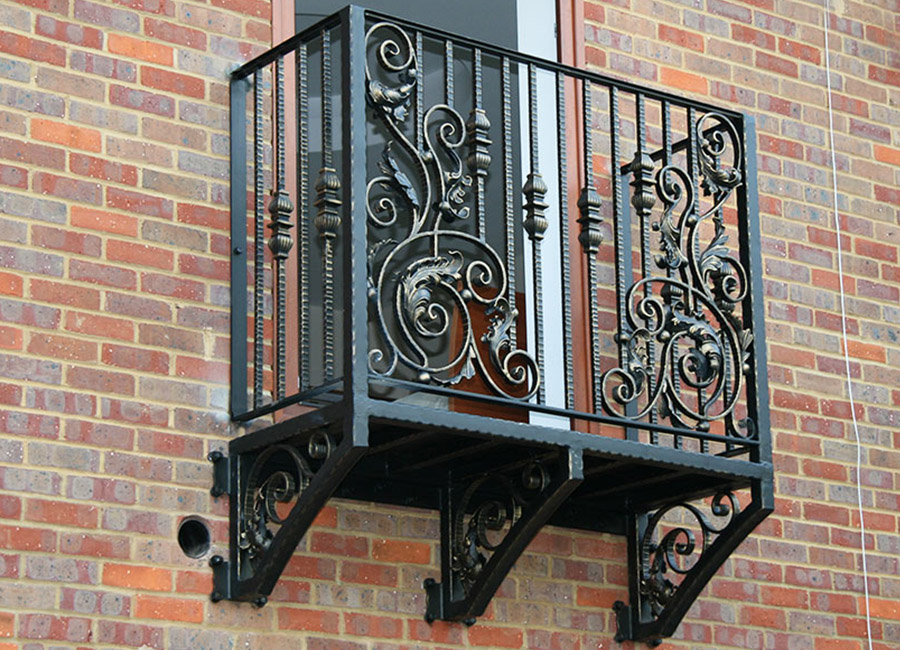 Forged items on the railing of a small balcony